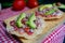 Mexican tuna tostadas and vegetables above a checkered tablecloth