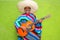 Mexican typical man playing guitar poncho