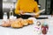 Mexican woman baking Pan de Muerto traditional bread from Mexico in Halloween