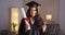 Mexican woman happily wearing cap and gown