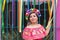 Mexican woman wearing embroidered dress and Lele doll headband.