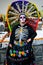 Mexico City, Mexico, ; November 1 2015: Portrait of a woman with colorful hat or penacho in disguise at the Day of the Dead celebr