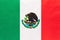 Mexico national fabric flag with emblem, textile background