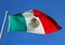 The Mexico national flag under the blue sky