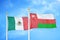 Mexico and Oman two flags on flagpoles and blue cloudy sky