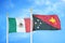 Mexico and Papua New Guinea two flags on flagpoles and blue cloudy sky