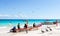 Mexico, Playa del Carmen - January 11, 2019: Tourists, locals and wild pelicans on a public beach on the Caribbean coast.