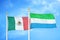 Mexico and Sierra Leone two flags on flagpoles and blue cloudy sky