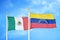 Mexico and Venezuela two flags on flagpoles and blue cloudy sky