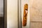 Mezuzah. Religious attribute at the entrance to a house. Decorative wooden Mezuzah at the entrance to a modern residential