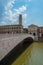 Mezzo Bridge over the River Arno, Tower of the Pretorio Palace and the Municipality of Pisa in Tuscany, Italy