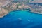 Mgiebah Bay, secluded cove accessible by a steep, rocky path, with a sandy beach and azure turquoise blue water. Mellieha, Malta.