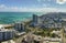 Miami Beach city with high luxury hotels and condos and sandy beachfront. High angle view of tourist infrastructure in