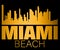 Miami Beach lettering and gold silhouette buildings on black backround. Travel card.