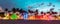Miami Beach Ocean Drive panorama with hotels and restaurants at sunset. City skyline with palm trees at night. Art deco