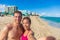 Miami beach selfie couple on summer holiday. Interracial young adults sun tanning on south beach, Florida, USA. Asian