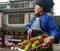 A Miao woman selling flowers at Fenghuang Ancient Town in Hunan, China