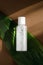 Micellar water, makeup remover transparent bottle mockup. Natural cosmetology liquid, organic cosmetics on green leaf background.