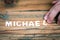 MICHAEL. Name of men and boys. Birthday concept. White letters of the alphabet on a wooden background