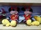 Mickey Mouse - shaped stuffed animals are displayed on the shelves, looking very cute