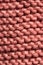 Micro close up of pink wooly crochet fabric with copy space