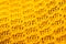 Micro close up of yellow crocheted woolly fabric with copy space