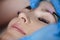 Microblading, micropigmentation eyebrows work flow in a beauty salon. Woman having her eye brows drawn and tinted. Semi-permanent