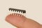 Microchip on finger of female hand on white background, research, development of microelectronics and processors, concept future