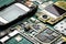 Microchips, semiconductor components and precious metals on the Board of the disassembled old mobile phone close-up on a green bac