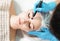 Microcurrent therapy for facial care. Cosmetologist doing face rejuvenation treatment