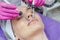 Microcurrent therapy for woman`s face in spa beauty salon