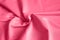 microfiber fabric pink color background with pleats, top view. toned in viva magenta, trend color