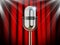 Microphone against red curtain with spotlights