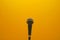 Microphone against stark yellow background