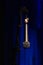 Microphone close hanging off microphone stand with blue background
