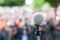 Microphone in focus against blurred protest or public demonstration