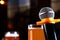 Microphone and a glass of beer on a dark background in the interior. The concept of a karaoke restaurant. Copy of the space