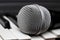 Microphone lies on the piano keys close up