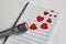 Microphone and paper red hearts are located on a clean music notebook. The concept of music and love. Valentine`s day