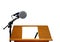 Microphone on podium with blank paper and pen