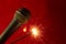 Microphone on red background and sparkler