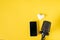 Microphone, smartphone and a white heart on a yellow background with a space for text.