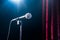 Microphone on a stand up comedy stage with reflectors ray, high contrast image