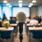 Microphone stands amidst blurred seminar room, speakers voice symbolized