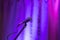 The microphone is turned on a multi-colored background, the background curtain is illuminated by different colored