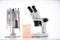 Microscope, petri dishes and pipette stand by microbiological laboratory