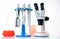 microscope, petri dishes and pipette stand by microbiological laboratory