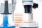 microscope, petri dishes and pipette stand by microbiological laboratory