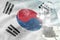 Microscope on Republic of Korea South Korea flag - science development conceptual background. Research in microbiology or