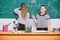 Microscope and test tubes on table. Chemical reactions. Make studying chemistry interesting. Pupil at chalkboard on